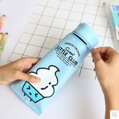 Light blue Toothpaste Pencil Case with cartoon design held by a person on a checkered background