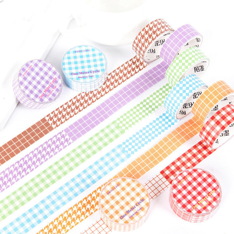 Set of colorful washi tape rolls with checkered patterns on a white background