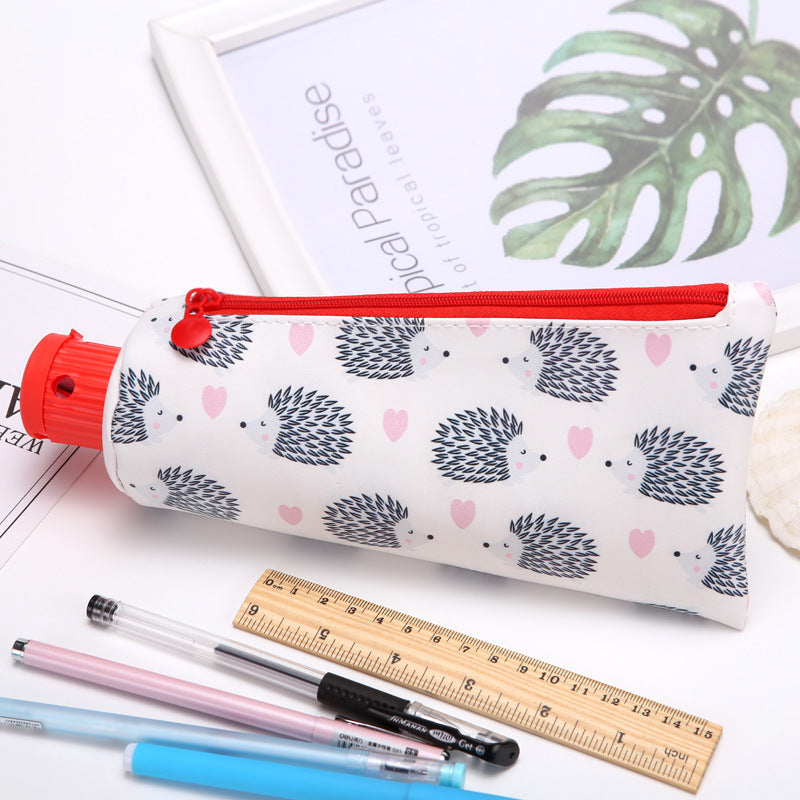 toothpaste Pencil case with hedgehog pattern on a surface with stationery items