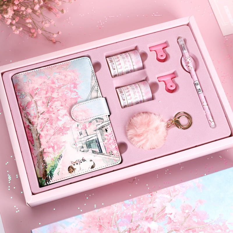 Stationery set with cherry blossom design in a pink box on a matching pink background
