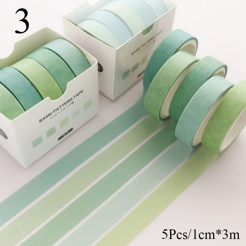 Set of green washi tape rolls with packaging on a white background
