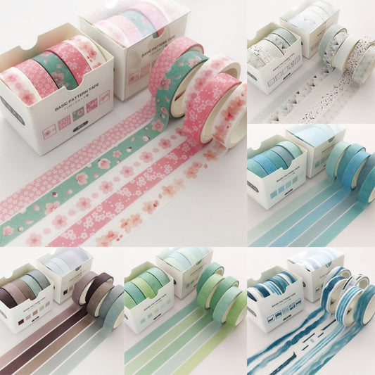 Set of decorative tape rolls with floral and striped patterns on a white background.