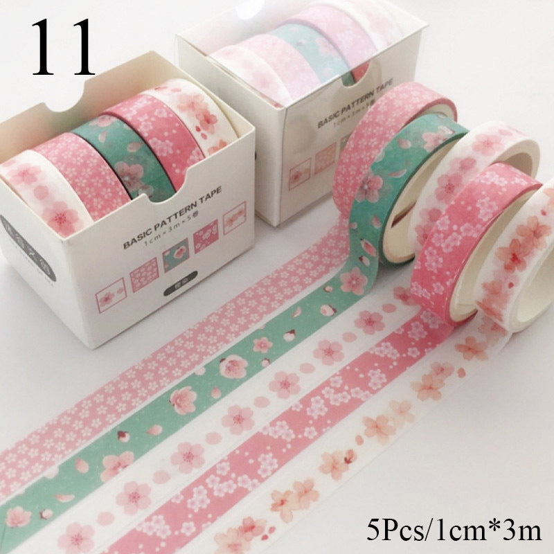 Set of floral-patterned tape rolls with packaging on a white background