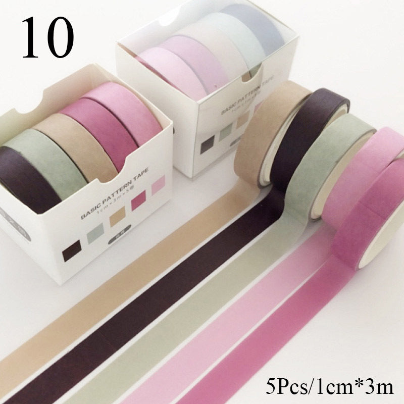 Set of colorful washi tape rolls with packaging on a white background