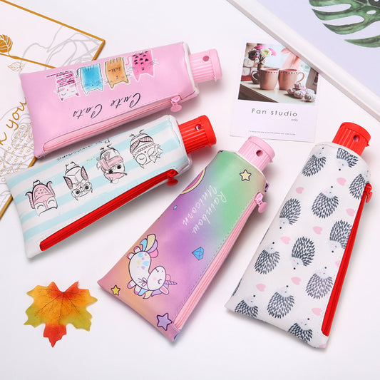 Set of 4 colorful pencil cases with cartoon designs on a white background