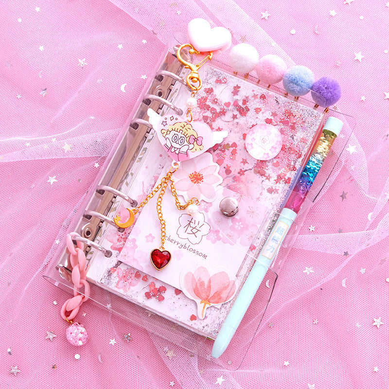 Decorative planner with accessories on a pink background