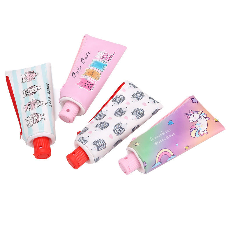 Four colorful Toothpaste tube-shaped Pencil Cases  with different designs on a white background