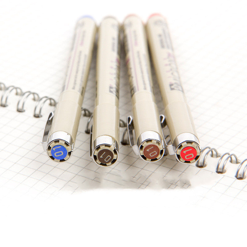 Set of mechanical pencils with colored buttons on a grid notebook background