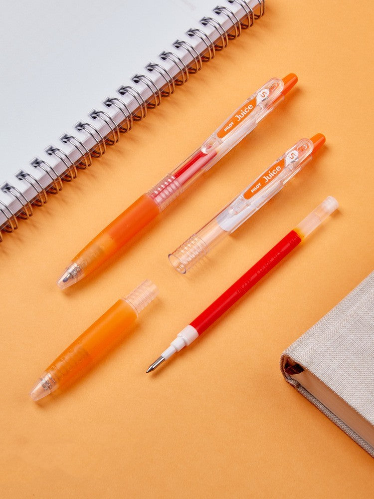 Pens with orange and red accents on a yellow background