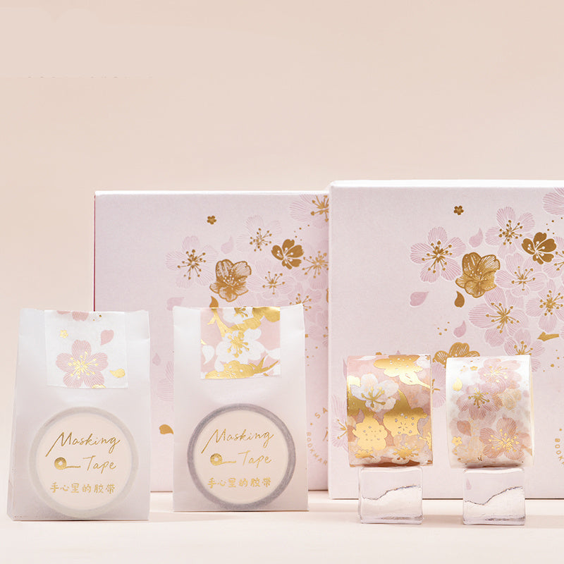 Set of floral-themed products with gold accents on a light background