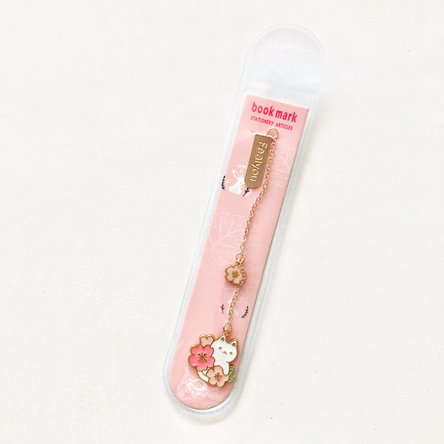 Pink bookmark with cat design and chain on a white background