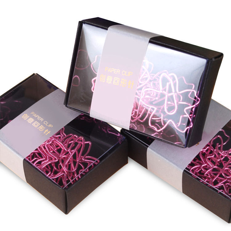 Pink paper clips in a black and white box on a white background