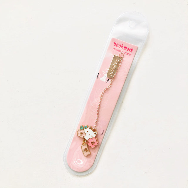 Pink bookmark with a cat design on a white background