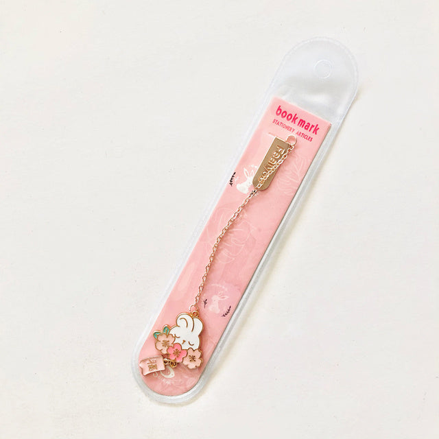 Decorative bookmark with floral design in a pink holder on a white background