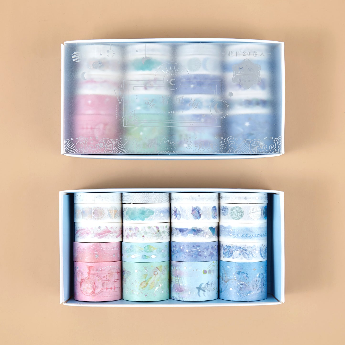 Set of pastel-colored washi tape rolls in a box on a beige background